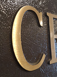 Brass letter C in Steele Centre plaque